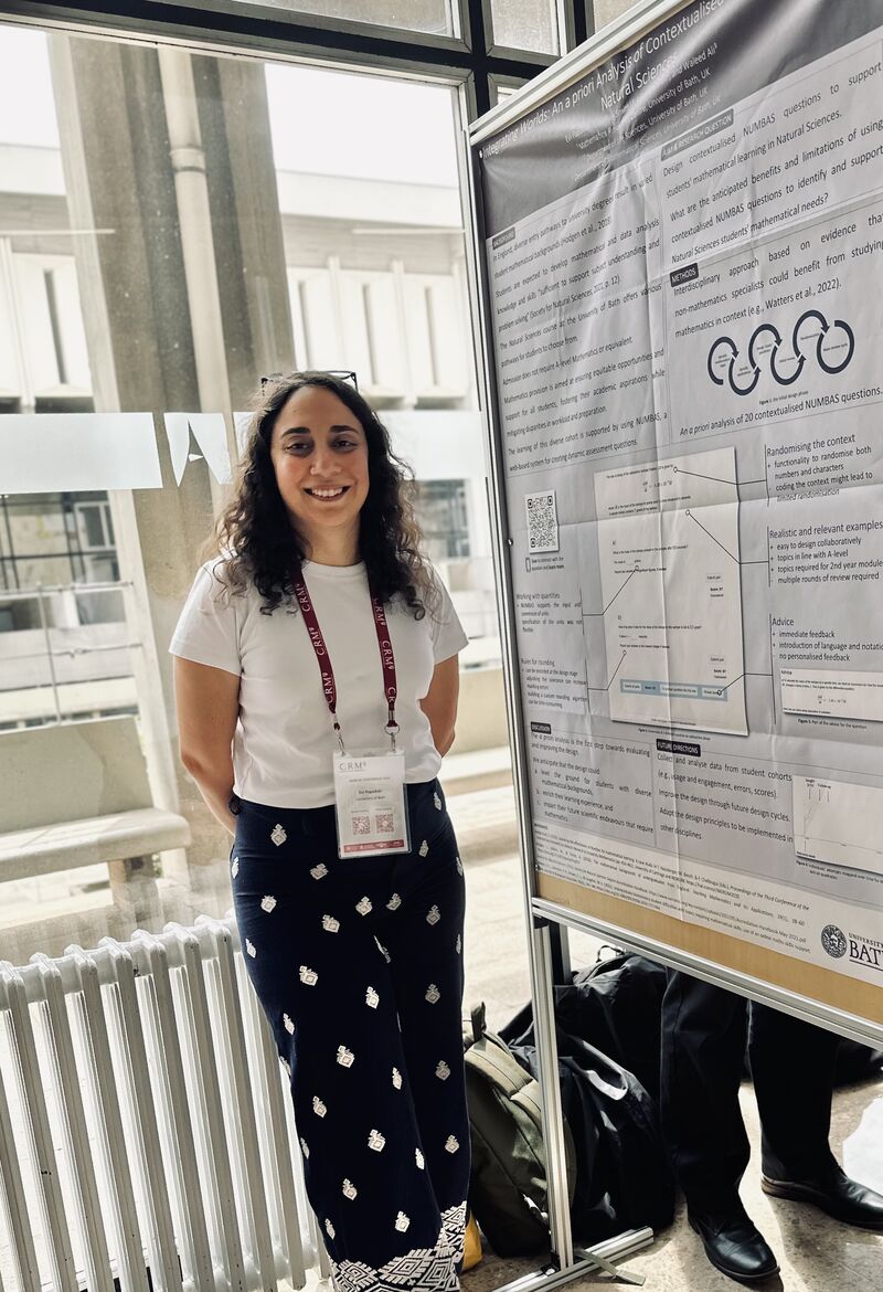 me standing next to my poster at the INDRUM2024 conference